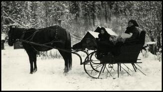 Louise and Phyllis Warren holding Rupert in horse-drawn sleigh