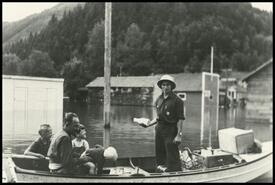 Joe Maier delivering milk during 1948 Sicamous flood