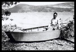 Seimatsu Takenaka sitting in his boat on the shore at Fintry