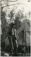 A.M. 'Bob' Chisholm holding gun at hunting camp