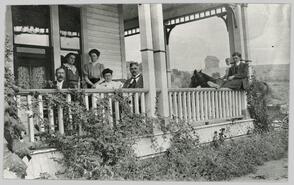 J.M Robinson and family on veranda at their home