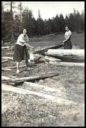 Gertrude Dixon and May Jurriet cutting wood at Mamette lake