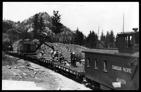 Work train and old steam shovel at work