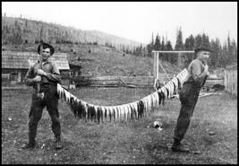 Henry and Wilfred Simard with string of fish