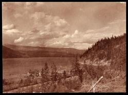 Little Shuswap with a farm in the foreground and railway tracks