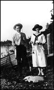 Unidentified man and a woman with the day's fish catch
