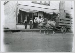 John S. Ritchie and George Fisher in front of J.S. Richie Boots & Shoe Repair shop