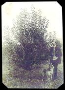 James Goldie posing next to apple tree