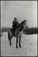 Young boy and child on horse in winter