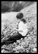 Edith Cahill sitting beside a creek