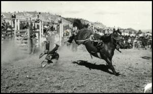 [Bronco riding event at rodeo]