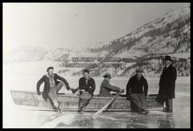 Men in boat on frozen Slocan Lake
