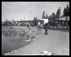 Polson Park fish pond, crowds, C.N.R. trestle in background