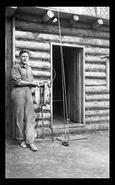 Dick Locke at fishing cabin in mountains with nice catch of fish