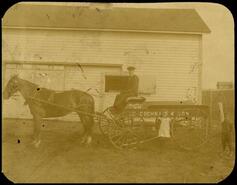 Man and two children with "C.P. Cochrane & Son" wagon