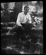 Cyril Wentworth sitting on a log