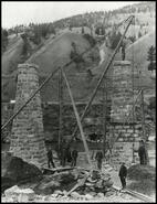 [Sheep Creek bridge construction crew with stone support towers]