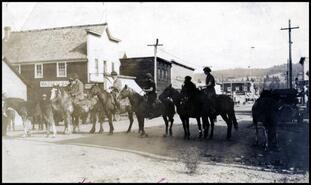 Group on horseback in front of Thomas Brothers Store
