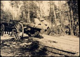 Ken Marples and unidentified man loading logs on a wagon