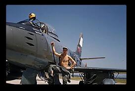 John Newlove standing beside his F-86 fighter
