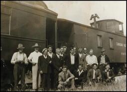 Group of men headed for war beside Canadian Pacific Train Caboose