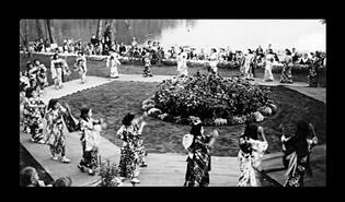 Women wearing kimonos dancing in park at waterfront