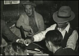 [Group of men playing mahjong in Chinatown store, Penticton]