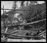 H.B. Kennard cooking over an open fire