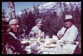J.R. Walters and Mr. and Mrs. Don Manly having a picnic lunch at Mt. Rainier