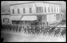 W.W. I soldiers marching past H.G. Parson store in Golden